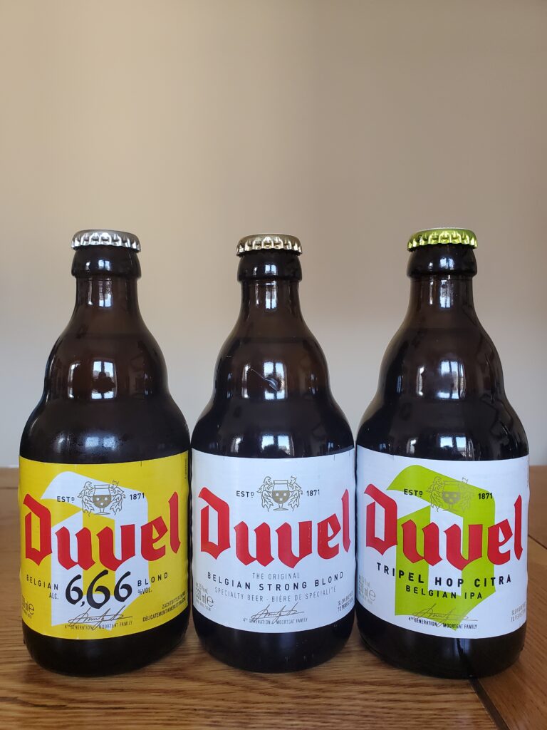 Three bottles of beer. From left to right: Duvel 666, Duvel Strong Blond, Duvel Tripel