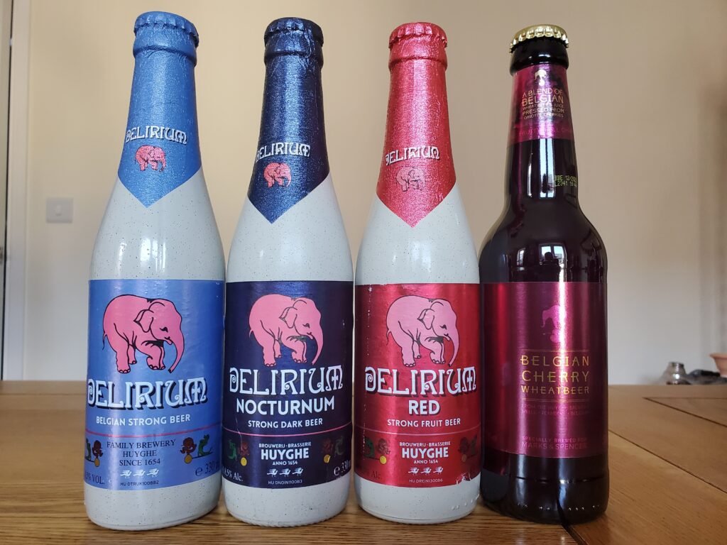 Four bottles of beer. From left to right: Delirium, Delirium Nocturnum, Delirium Red and Belgian Cherry Wheat beer