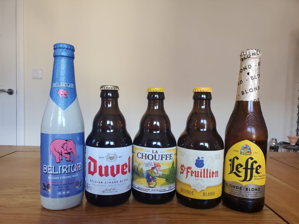 A selection of five Belgian blond beers in bottles.